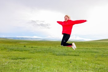 Photo of Woman Jumping on Grass Field