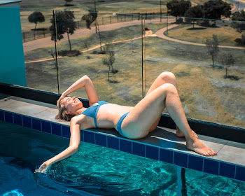 Photo of Woman Laying Beside Pool