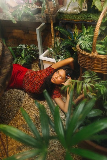 Photo Of Woman Laying Near Plants