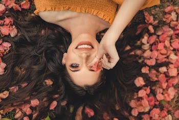 Photo Of Woman Laying On Petals