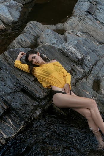 Photo Of Woman Laying On Rock Formation