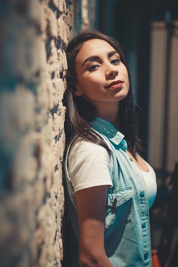 Photo of Woman Leaning Against Wall