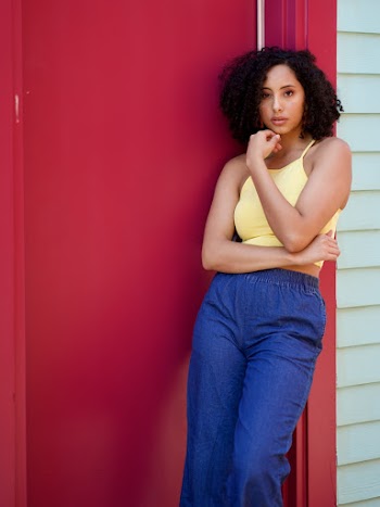 Photo of Woman Leaning Backward on Doorway Posing