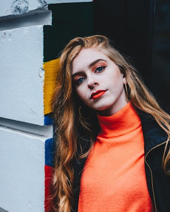 Photo of Woman Leaning Head Against Wall