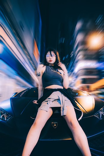 Photo of Woman Leaning In Front Of Car