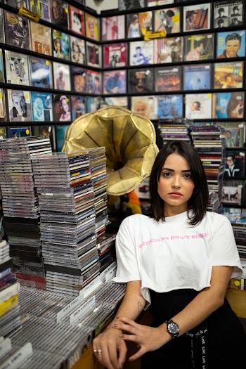 Photo of Woman Leaning Near Gramophone