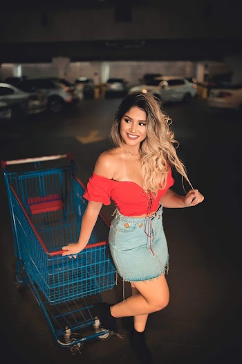Photo of Woman Leaning On Blue Shopping Cart