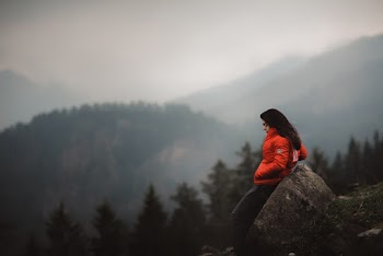 Photo of Woman Leaning on Boulder