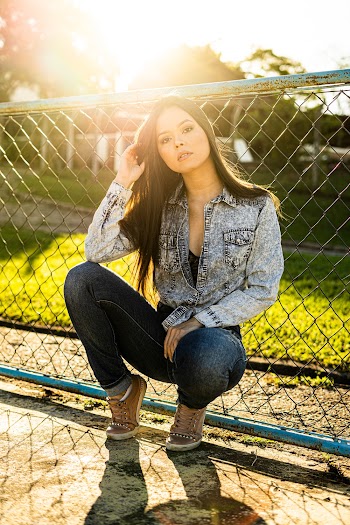 Photo of Woman Leaning On Chain-link Fence