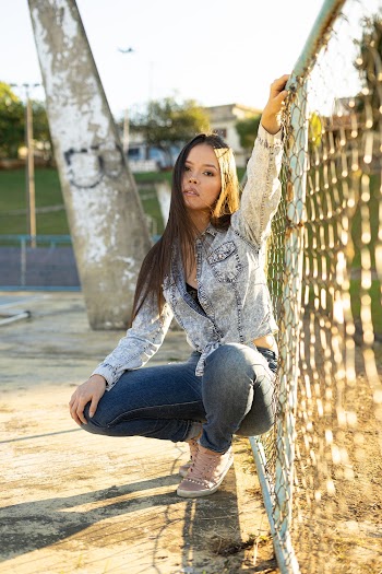 Photo of Woman Leaning On Chain-link Fence