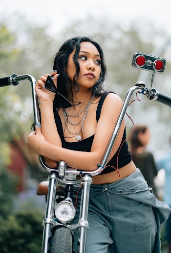 Photo of Woman Leaning on Chopper Motorcycle