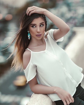 Photo Of Woman Leaning On Concrete Railing
