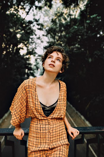 Photo of Woman Leaning On Fence