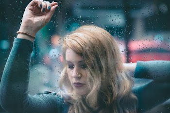 Photo Of Woman Leaning On Glass