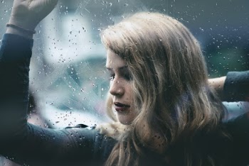 Photo Of Woman Leaning On Glass 