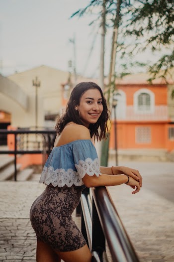 Photo of Woman Leaning on Handrail
