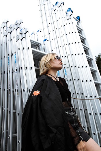Photo Of Woman Leaning On Ladder