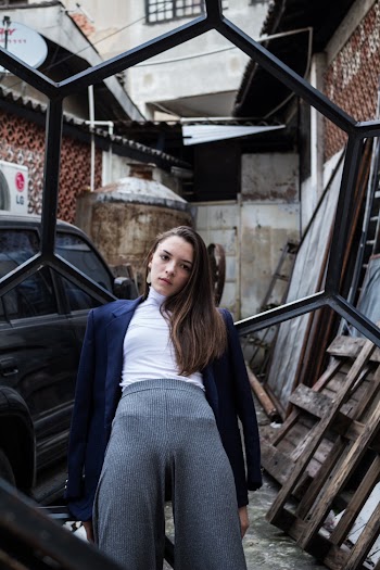 Photo Of Woman Leaning On Metal Frame