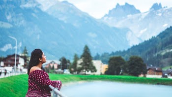 Photo of Woman Leaning on Metal Railings