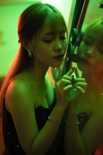 Photo of Woman Leaning On Mirror