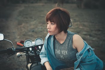 Photo Of Woman Leaning On Motorcycle