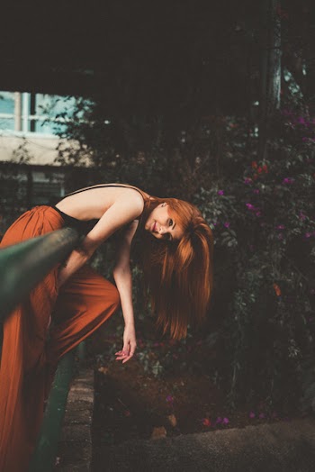 Photo of Woman Leaning on Railing