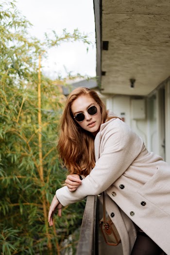 Photo of Woman Leaning on Railings