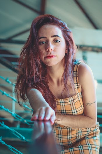 Photo of Woman Leaning on Railings