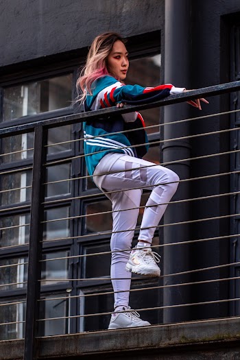 Photo of Woman Leaning on Railings