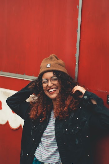 Photo Of Woman Leaning On Red Wall