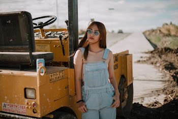 Photo Of Woman Leaning On Road Roller