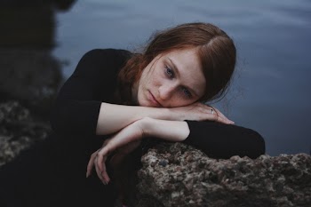 Photo of Woman Leaning On Rock