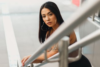 Photo of Woman Leaning on Stair Railing