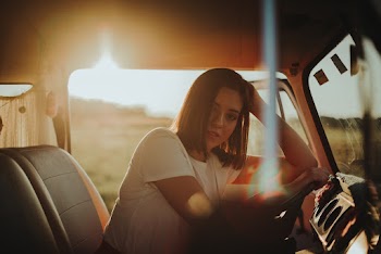 Photo of Woman Leaning on Steering Wheel