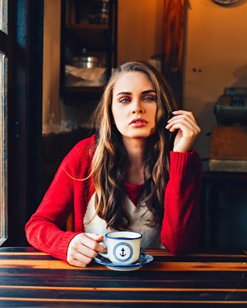 Photo of Woman Leaning on Table