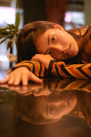 Photo of Woman Leaning on Table