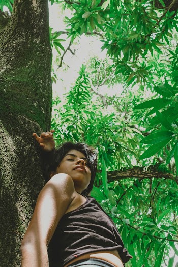 Photo of Woman Leaning on Tree