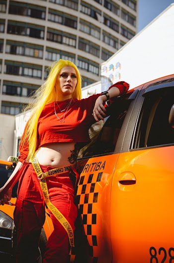 Photo of Woman Leaning on Vehicle