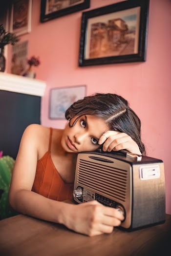Photo of Woman Leaning On Vintage Radio