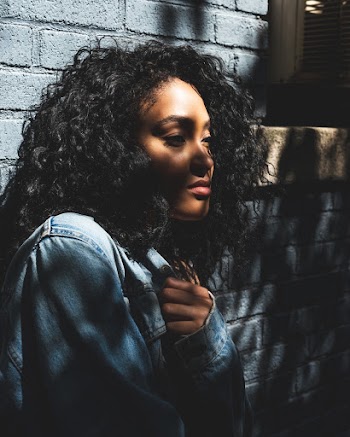 Photo Of Woman Leaning On Wall