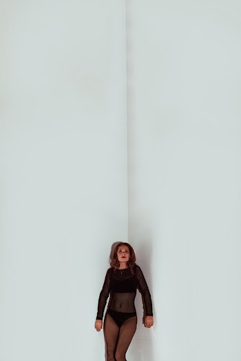 Photo Of Woman Leaning On Wall