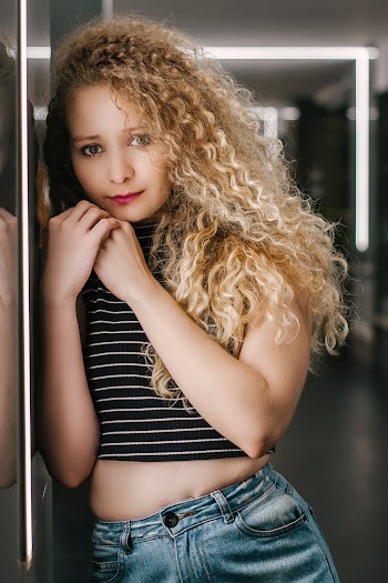 Photo of Woman Leaning on Wall Posing