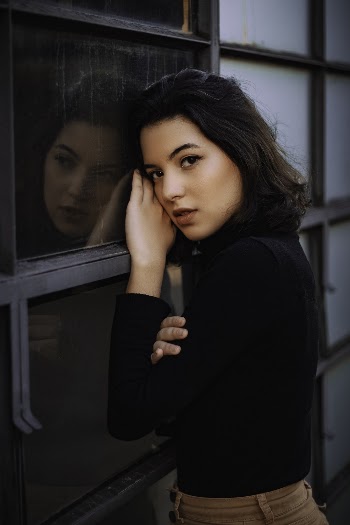 Photo of Woman Leaning On Window