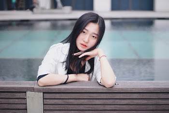Photo Of Woman Leaning On Wooden Bench