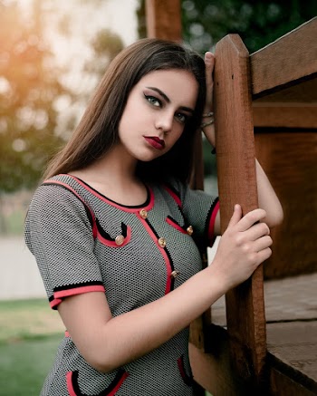 Photo of Woman Leaning On Wooden Fence
