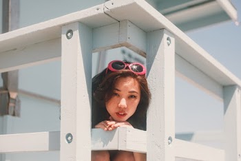 Photo Of Woman Leaning On Wooden Fence