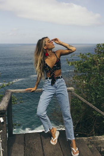 Photo of Woman Leaning on Wooden Handrail