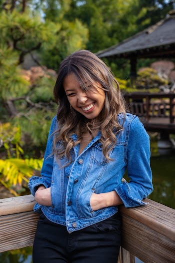 Photo of Woman Leaning on Wooden Railing