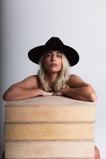 Photo Of Woman Leaning On Wooden Surface