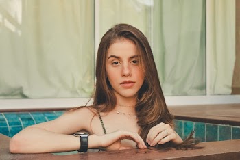 Photo Of Woman Leaning On Wooden Surface
